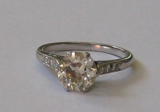 A lady's particularly attractive 18ct white gold or platinum engagement ring, set a large diamond (approx 1.09ct) and 6 diamonds to the shoulders