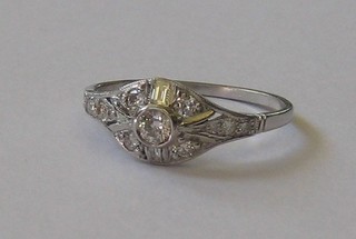 A lady's 18ct white gold dress ring set a circular central diamond surrounded by numerous diamonds