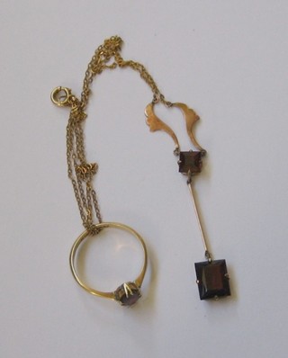 An 18ct gold dress ring set an oval garnet and a matching pendant hung on a gold chain 