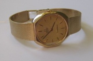 A gentleman's Omega Constellation quartz wristwatch contained in a 9ct gold case complete with a 9ct gold integral bracelet
