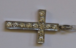 An 18ct white gold cross pendant set 15 diamonds