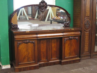 A  Victorian  mahogany  sideboard  with  arch  shaped   mirrored back,  the base fitted 3 drawers above triple cupboards, raised  on a platform base 72"