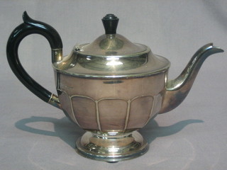 A circular silver plated teapot