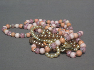 A  string  of  1920's  hardstone beads together  with  a  string  of simulated pearls