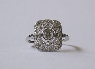 A  white  gold  Art  Deco  style dress  ring  set  a  large  circular diamond   supported   by  numerous  diamonds   approx.   0.65ct