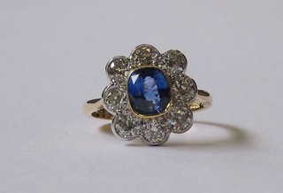 A  lady's  attractive  18ct yellow gold dress ring set  an  oval  cut Tanzanite   surrounded   by  8   diamonds   approx.   1.25/1.70ct