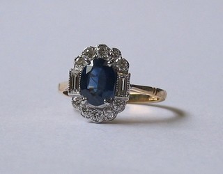 A  lady's  yellow  gold  dress ring  set  an  oval  square  sapphire supported  by  2  baguette cut diamonds and  10  other  diamonds
