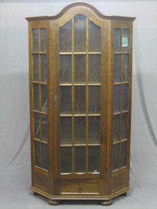 An   oak  bookcase,  the  shelved  interior  enclosed  by   astragal glazed panelled doors 42"