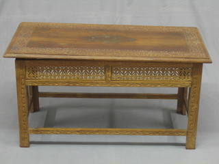 A  19th/20th Century rectangular Eastern carved and inlaid  brass occasional table, raised on a pierced hardwood folding stand  37"
