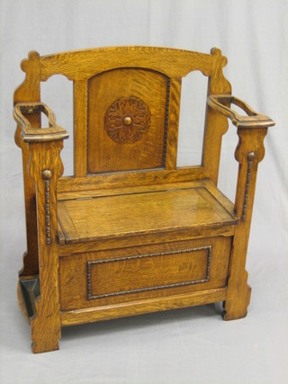 A  1930's  honey  oak hall seat incorporating  an  umbrella  stand complete with drip tray, 29"