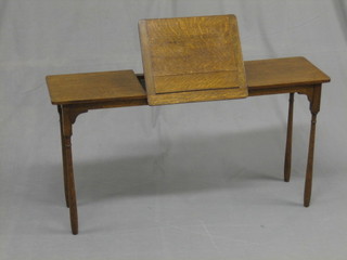 A  rectangular oak reading/music stand raised on turned  supports 37"