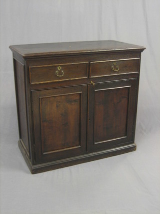An  18th/19th Century Continental oak cabinet, fitted  2  drawers above a double cupboard, raised on a platform base 36"