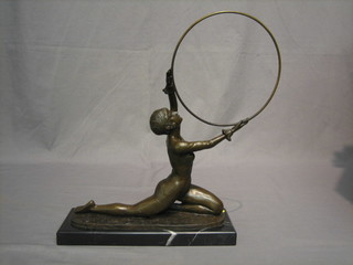 A  reproduction  Art  Deco bronze figure of  a  lady  with  hoop, raised on a black marble base 13"