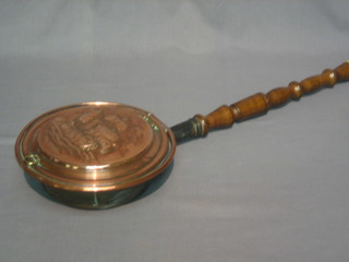 A  copper  warming pan, the lid embossed a galleon  in  full  sail, with turned fruit wood handle