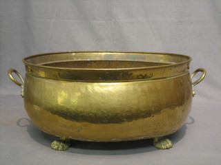 An  oval  twin handled brass planter raised on paw  supports  20"