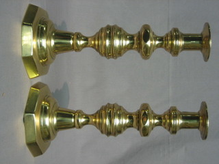 A handsome pair of 19th Century brass candlesticks with ejectors raised on octagonal bases 12"