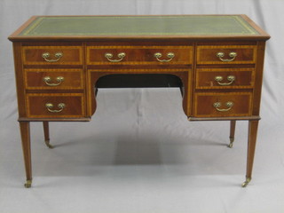 An  Edwardian  inlaid  mahogany  writing  table/desk  with  inset tooled  leather writing surface, fitted 1 long and 6 short  drawers,  raised on square tapering supports 48"