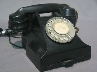 A black Bakelite dial telephone, the base marked 3321