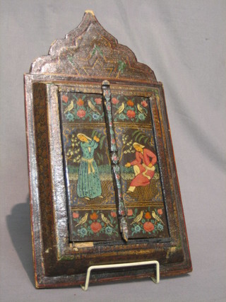 An Eastern rectangular plate mirror contained in a lacquered  and painted shuttered frame 15"