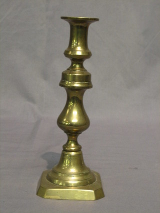 A brass candlestick with ejector 10"