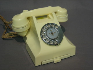 A   white   Bakelite  dial  telephone,  the  base   marked   332CB PX56/2a