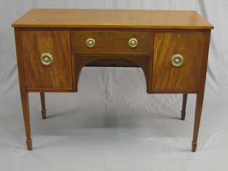 A Georgian  mahogany sideboard fitted 1 long door flanked by  a pair  of  cupboards, raised on square tapering supports  ending  in  spade feet 44" 