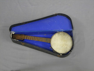 A  4  stringed banjo with 8" drum having 6 bolts to the  side  and with metal back, cased