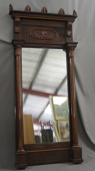 A  Regency  rectangular plate  mirror contained  in  a  mahogany frame flanked by a pair of columns 69"
