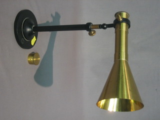 A  brass  trumpet  shaped instrument 8" raised on  an  iron  retort