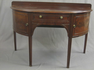 A  19th Century mahogany demi-lune side table, fitted  a  drawer and  flanked  by  a  pair of cupboards,  raised  on  square  reeded supports 51"