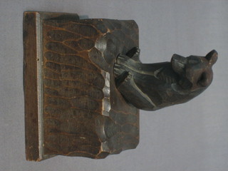 A  Bavarian  carved  wooden wall mounting  match  box  holder? surmounted by a figure of a bear 