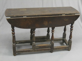 A 17th/18th Century oak oval drop flap gateleg dining table (leaf of flap reduced in length)