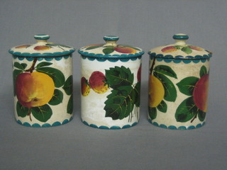 3  Wemyss cylindrical pottery preserve jars decorated plums,  the inside of the lids marked Made in England (1 with crack to  body and lid, 1 with chips to lid)