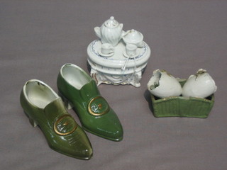 A  miniature  trinket box, the lid decorated a tea  service  (af),  a pair  of  miniature green glazed shoes and a miniature  basket  (f)