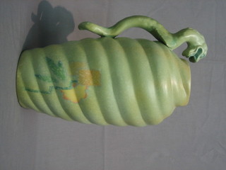 A  green  glazed  Art  Pottery vase the handle in  the  form  of  a dragon 13" (slight crack)