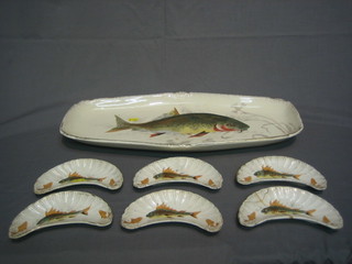 A  Continental  pottery 7 piece fish service comprising  oval  fish plate 21" and 6 crescent shaped salad dishes  6 1/2" (1 f)