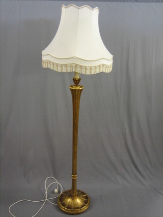 A gilt painted and reeded standard lamp