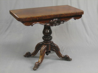 A Victorian rosewood D shaped card table raised on a tripod base 36"