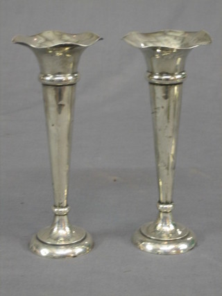 A pair of silver trumpet shaped vases raised on circular spreading feet, Birmingham 1912 8" (some dents)
