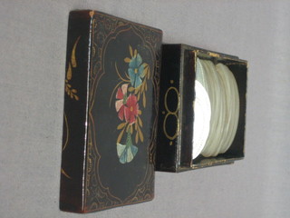 An  Eastern lacquered box containing approx 44 oval  mother  of pearl engraved game counters