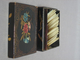 An  Eastern lacquered box containing approx. 36 circular  mother of pearl engraved game counters