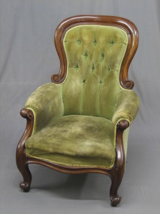 A Victorian mahogany show frame armchair upholstered in green buttoned material, raised on cabriole supports