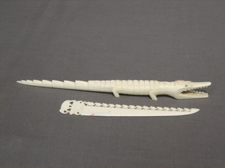 An  ivory  paper knife decorated a bridge of elephants  7"  and  a carved ivory crocodile 10"