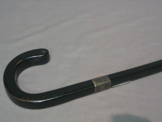 A gentleman's ebony walking stick with silver band