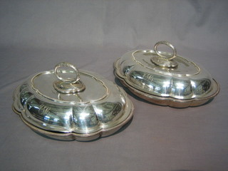 A  pair  of  oval  shaped silver  plated  entree  dishes  and  covers 