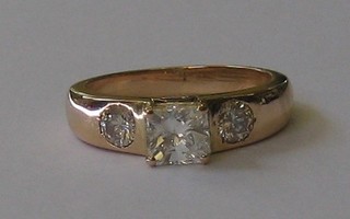 A  lady's  18ct  yellow  gold  dress ring  set  a  large  square  cut diamonds,  supported by 2 circular cut diamonds (approx  1.50ct)