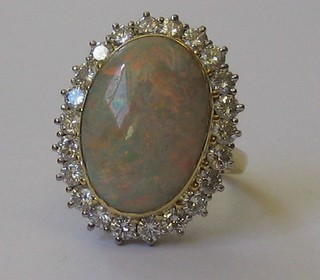 An  18ct  gold dress ring set a large oval opal surrounded  by  22 diamonds