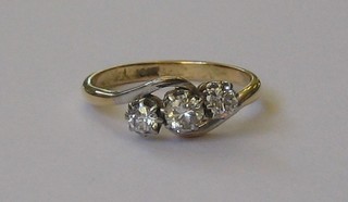 An 18ct gold crossover dress ring set 3 diamonds