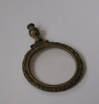A  19th  Century quizzing glass contained in a  gilt  metal  mount