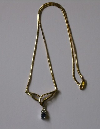 An oval sapphire pendant surmounted by 3 small diamonds, hung on a fine gold chain